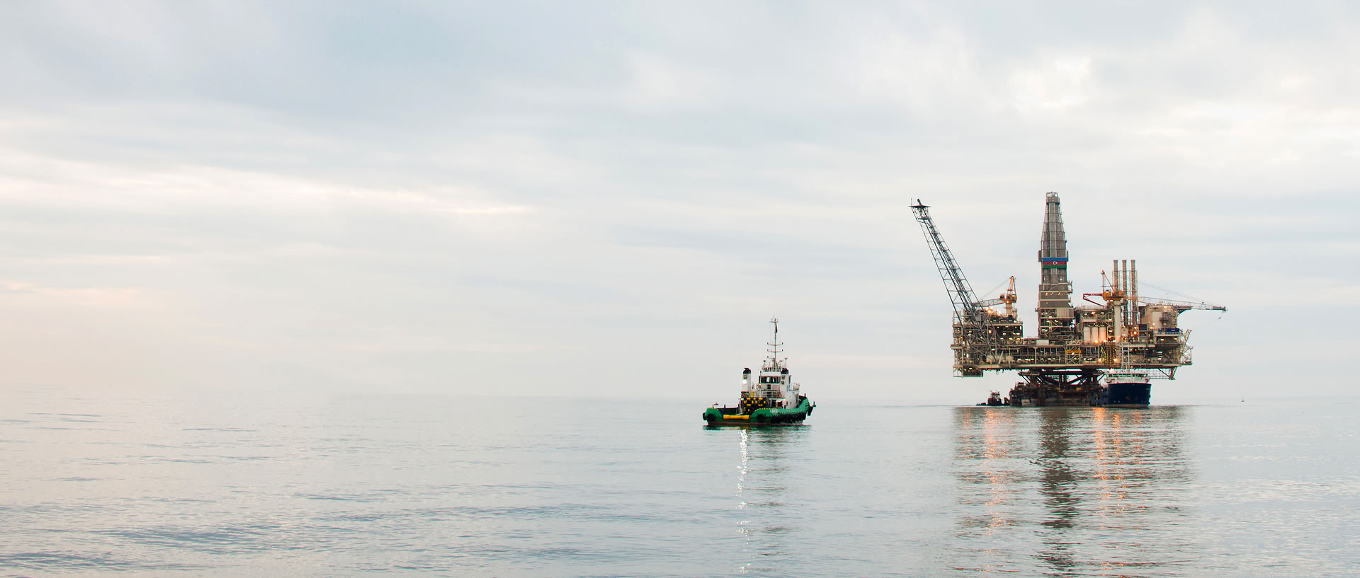 Oil Rig And Boat In Daylight